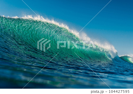 Surfing wave in ocean. Crashing turquoise wave in Florianopolis 104427595