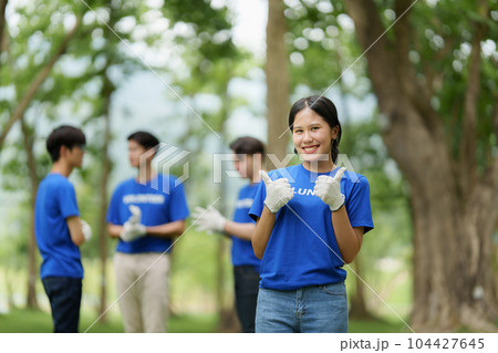 Young Asian Volunteers with garbage bags cleaning park area. Ecology, Charitable organization concept 104427645