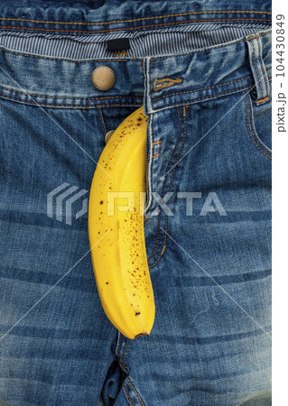 Yellow banana sticks out of a blue pants jeans Yellow banana sticks out of a blue pants jeans 104430849