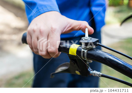 A man adjusts the throttle on the handle of a walk-behind tractor before starting work. Running in, industry 104431711