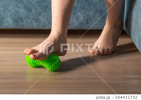 Medical foot massager. Removal of fatigue on the legs, relaxation. Home physiotherapy. Copy space for text 104431732