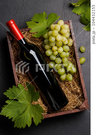 A red wine bottle and fresh grapes A red wine bottle and fresh grapes 104432155