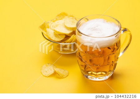 A tempting snack of beer and chips A tempting snack of beer and chips 104432216