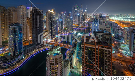 View of various skyscrapers in tallest recidential block in Dubai Marina aerial day to night timelapse 104432479