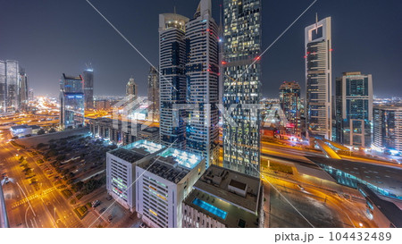 Aerial view of Dubai International Financial District with many skyscrapers day to night timelapse. Aerial view of Dubai International Financial District with many skyscrapers day to night timelapse. 104432489