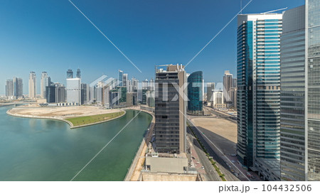 Cityscape skyscrapers of Dubai Business Bay with water canal aerial timelapse. 104432506