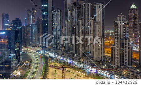 Bay Avenue with modern towers residential development in Business Bay aerial all night timelapse, Dubai 104432528