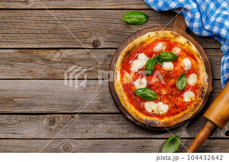 Margarita pizza with tomatoes, mozzarella cheese and basil Margarita pizza with tomatoes, mozzarella cheese and basil 104432642