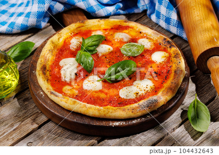 Margarita pizza with tomatoes, mozzarella cheese and basil Margarita pizza with tomatoes, mozzarella cheese and basil 104432643