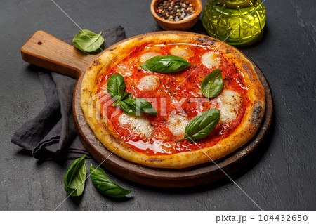 Margarita pizza with tomatoes, mozzarella cheese and basil Margarita pizza with tomatoes, mozzarella cheese and basil 104432650