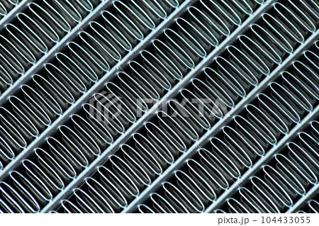 Texture of a honeycomb of an automotive aluminum car cooling radiator, close-up. Texture of a honeycomb of an automotive aluminum car cooling radiator, close-up. 104433055