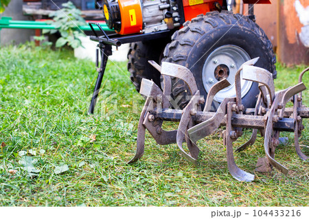 cutters complete with walk-behind tractor for work on the ground. Technique for agriculture. Motor cultivator. Copy space for text 104433216