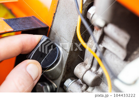 holes for pouring gear oil into the walk-behind tractor. Maintenance of equipment, industry. Close-up 104433222