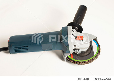 Modern professional angle grinder with a flap wheel on a white background. Power tool for work. Sanding wood and metal. 104433288