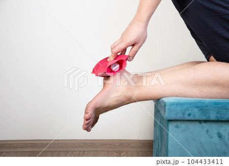 Heel spur treatment with hot water bottle. Heat therapy. Copy space for text 104433411