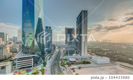 Dubai International Financial district aerial night to day timelapse. Panoramic view of business office towers. Dubai International Financial district aerial night to day timelapse. Panoramic view of business office towers. 104433980