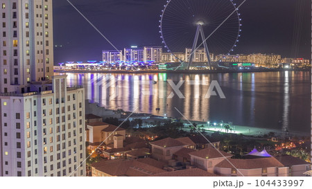 Bluewaters island with modern architecture and ferris wheel aerial day to night timelapse. 104433997