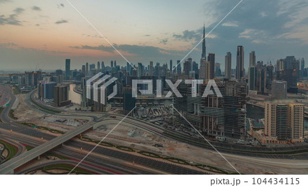Skyline with modern architecture of Dubai business bay towers at sunset timelapse. Aerial view Skyline with modern architecture of Dubai business bay towers at sunset timelapse. Aerial view 104434115
