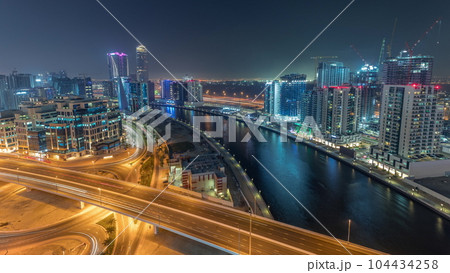 Skyscrapers at the Business Bay aerial day to night timelapse in Dubai, United Arab Emirates 104434258