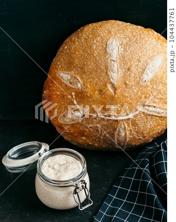 Wheat round sourdough bread, copy space, vertical 104437761