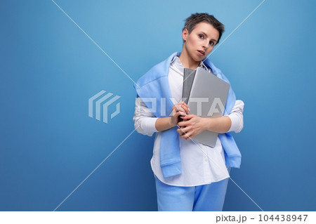 confident stylish freelancer woman with laptop on studio background 104438947