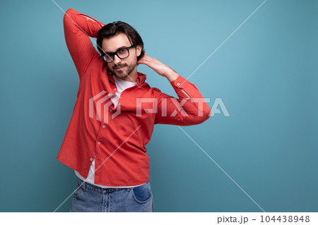 young handsome guy with a brutal stylish hairstyle in a red shirt young handsome guy with a brutal stylish hairstyle in a red shirt 104438948