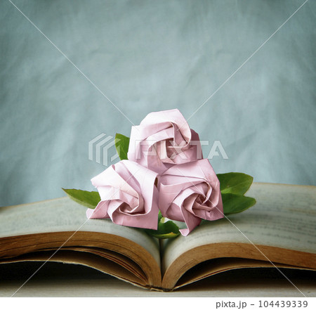Valentine Abstract with Three Pink Roses is on Vintage Book. Still Life and Vintage Style. Background Sweet Love Template with copy space for the Valentine's Day Concept banner. 104439339