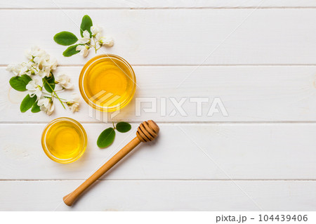 honey jar with acacia flowers and leaves. fresh honey top view flat lay honey jar with acacia flowers and leaves. fresh honey top view flat lay 104439406