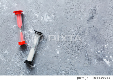 hourglass on the table, sand clock as time passing concept for business deadline, copy space 104439543