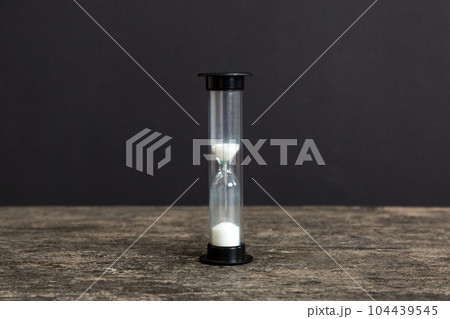hourglass on the table, sand clock as time passing concept for business deadline, copy space 104439545