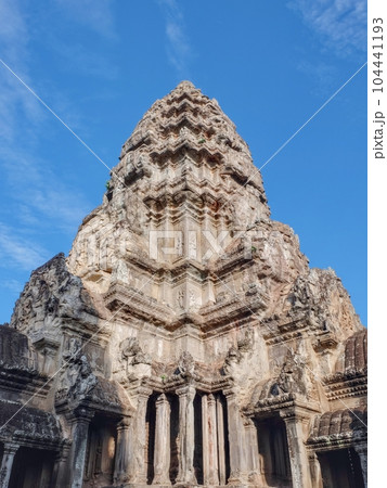 Angkor Wat's ornate stone tower on sunny day. 104441193