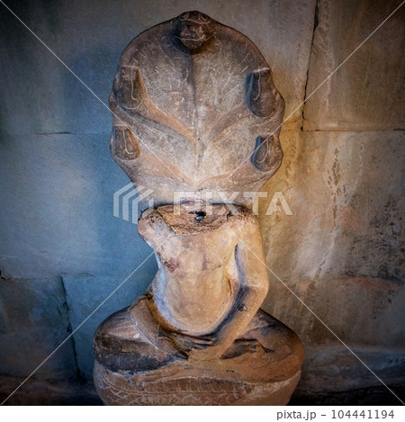 A headless Buddha statue in the lotus pose captured inside a Cambodian temple. A headless Buddha statue in the lotus pose captured inside a Cambodian temple. 104441194