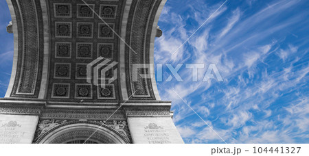 Arc de Triomphe (against the background of sky with clouds), Paris, France. The walls of the arch are engraved with the names of 128 battles and names of 660 French military leaders (in French) Arc de Triomphe (against the background of sky with clouds), Paris, France. The walls of the arch are engraved with the names of 128 battles and names of 660 French military leaders (in French) 104441327