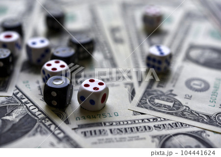 Dollar bills and dice. Financial games. Speculation. 104441624