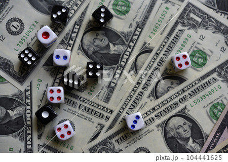 Dollar bills and dice. Financial games. Speculation. 104441625