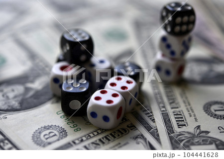 Dollar bills and dice. Financial games. Speculation. 104441628
