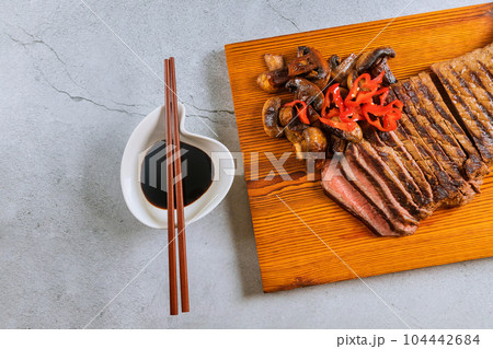 It is juicy tender medium rare beef steak that is sliced thinly. 104442684