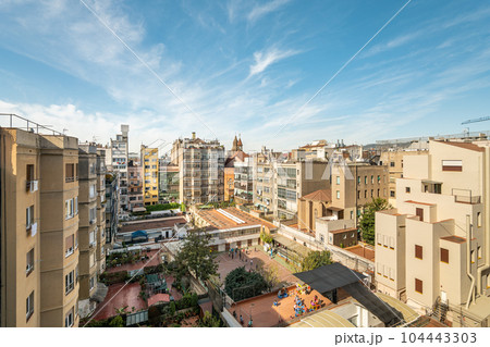Cityscape of residential district in barcelona with impressive architecture against a clear sky 104443303