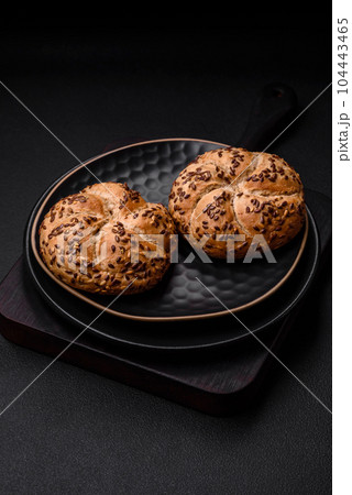 Delicious freshly baked crispy bun or kaiser roll with sesame seeds 104443465
