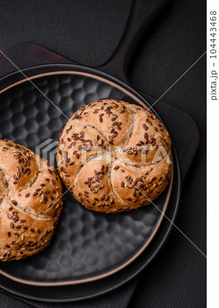 Delicious freshly baked crispy bun or kaiser roll with sesame seeds 104443468