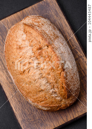 Delicious fresh baked crispy loaf of bread with seeds and grains 104443487