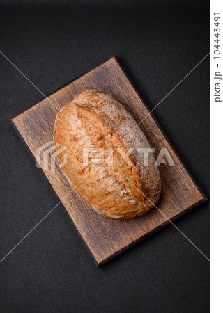 Delicious fresh baked crispy loaf of bread with seeds and grains Delicious fresh baked crispy loaf of bread with seeds and grains 104443491