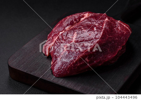 Fresh raw beef steak with salt, spices and herbs Fresh raw beef steak with salt, spices and herbs 104443496