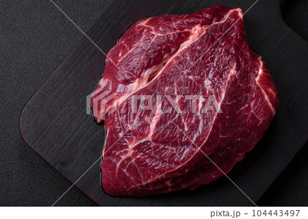 Fresh raw beef steak with salt, spices and herbs 104443497