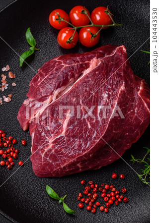 Fresh raw beef steak with salt, spices and herbs 104443530