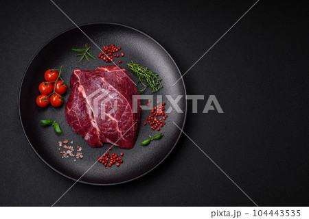 Fresh raw beef steak with salt, spices and herbs 104443535