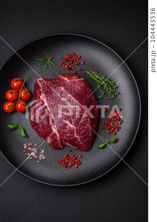 Fresh raw beef steak with salt, spices and herbs 104443536