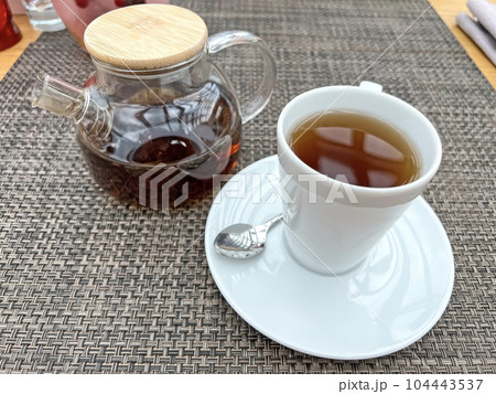 Teapot with tea and a cup on the table  104443537