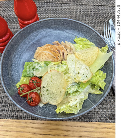 Caesar salad with chicken and crackers 104443538