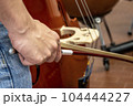 Real life young music students during rehearsals. Musical instruments and music stand with stave. 104444227